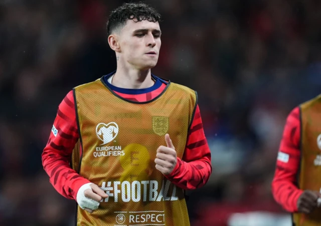 England's Phil Foden warming up on the touchline