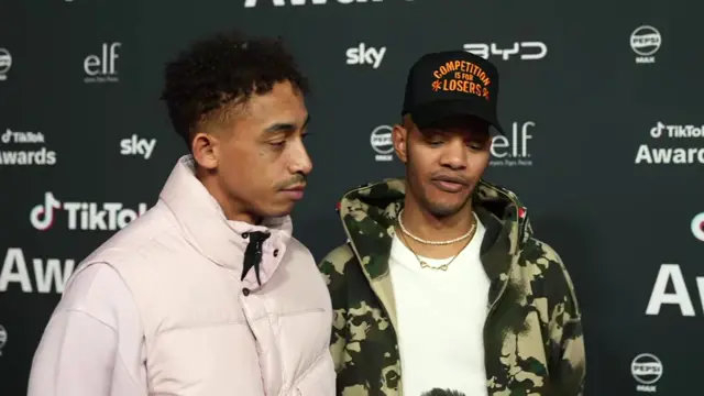 Jordan Stephens and Harley Sylvester on pink carpet