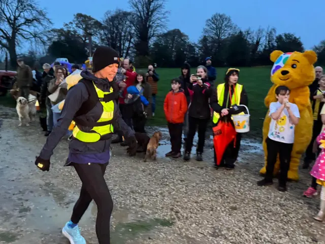 Sara passes a crowd of supporters