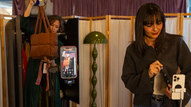 Two girls film trying on clothes