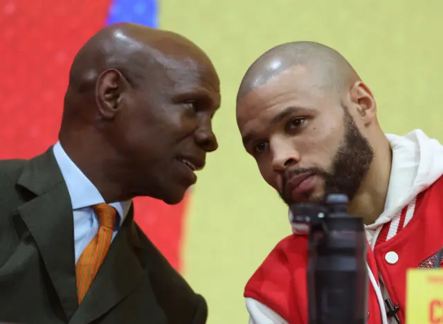 Chris Eubank Sr talking in the ear of Chris Eubank Jr.