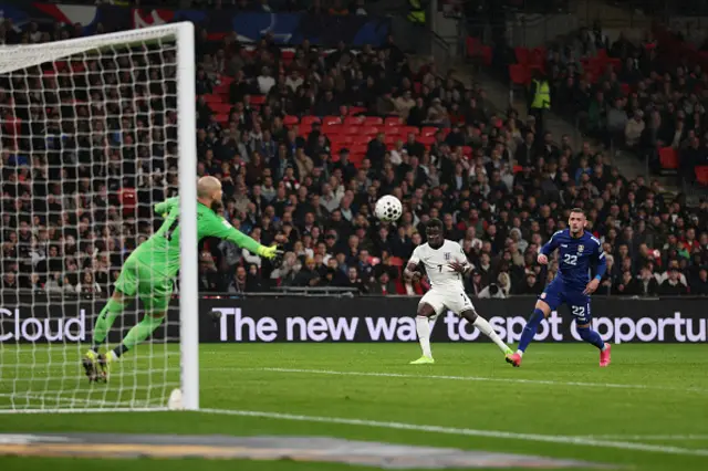 Bukayo Saka of England scores his team's first goal