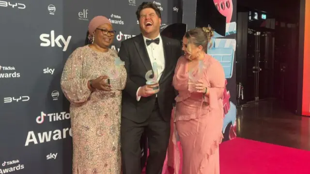 Bus Aunty, Morgan and Charley Marlowe smiling together on the TikTok red carpet