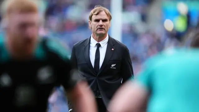 Scott Robertson looks on