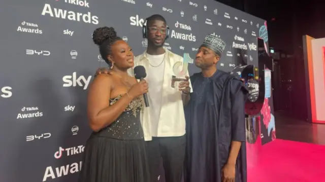 Kevin and his parents on the red carpet