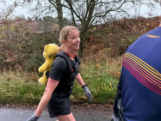 Sara grimaces while walking