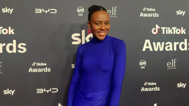 Aghogho Okphara in a electric blue dress as she poses for pictures on the red carpet
