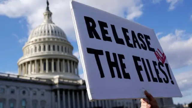A protester holds a sign outside Congress which says 'release the files'