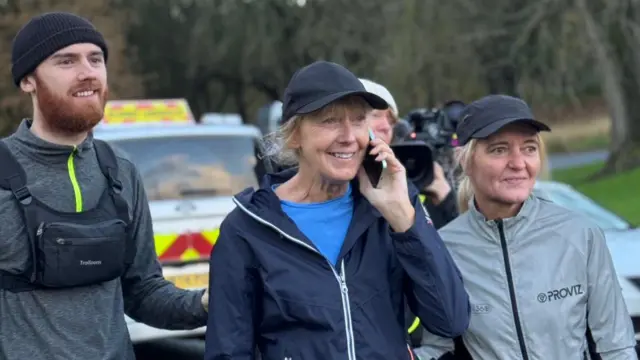 Sara's sister Dot chats to Scott Mills on the phone and arranges to intercept Sara en route