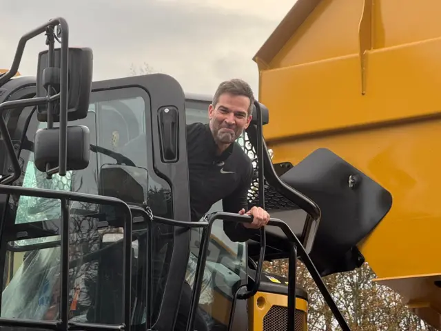 Gethin leans out of a tractor