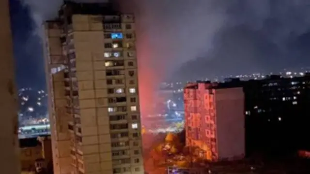 A screengrab from a video showing damage and smoke at a high-rise block of flats in Kyiv