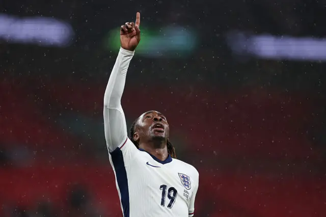 Eberechi Eze points to the sky after scoring for England