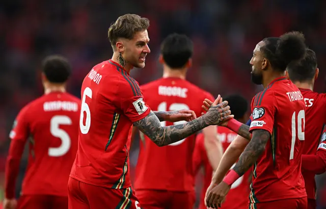Wales defender Joe Rodon celebrates scoring a goal with Sorba Thomas