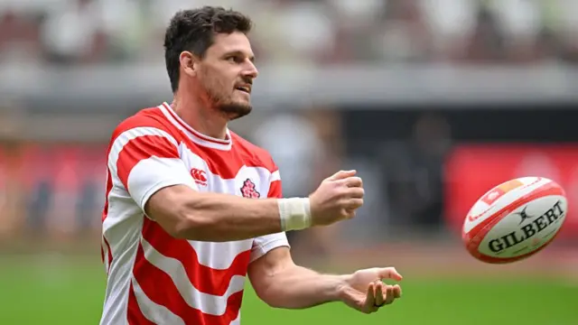 Japan flanker Jack Cornelsen passes the ball