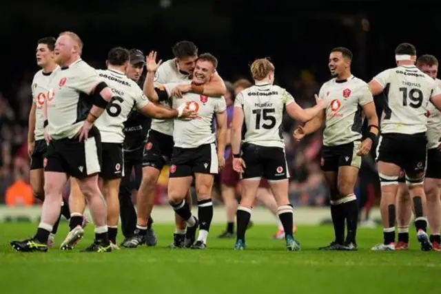 Jarrod Evans is congratulated by his Wales team-mates after his winner against Japan