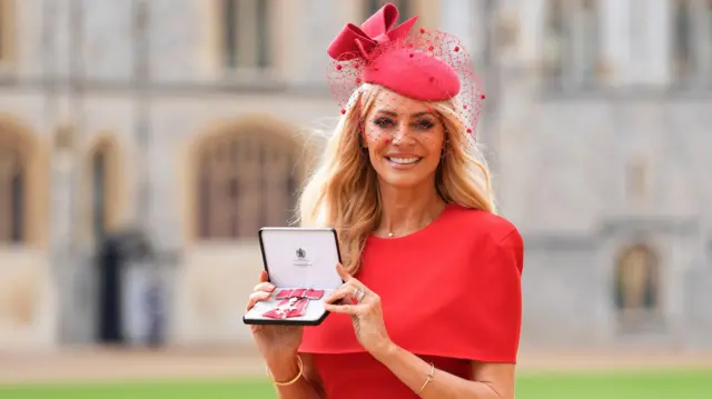 Tess Daly holds her MBE