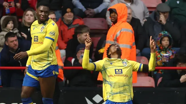 Kyreece Lisbie raises two hands into the air in celebration