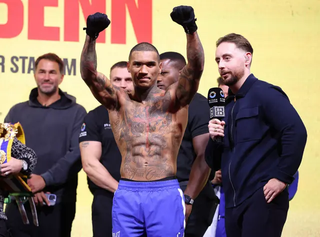 Conor Benn with his hands raised at the weigh-in