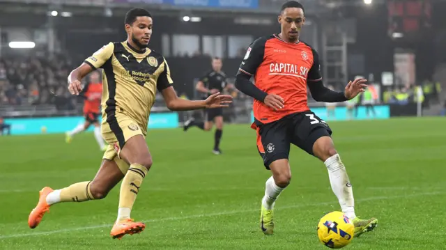 Cohen Bramall of Luton tries to dribble away from Denzel Hall of Rotherham United