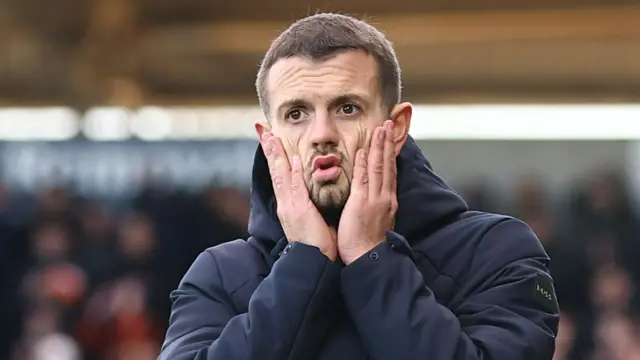Jack Wilshere with hands on his cheeks