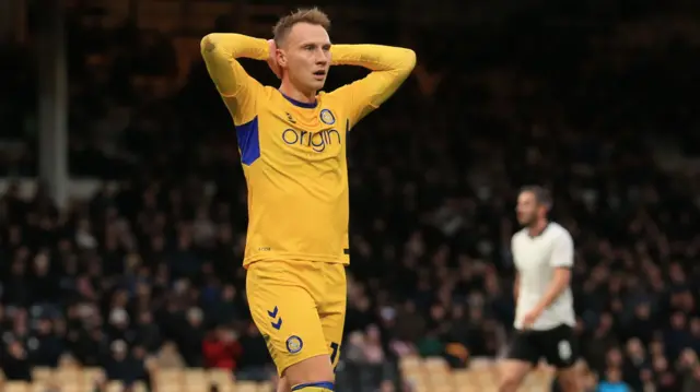 Port Vale striker Cauley Woodrow has his head in his hands