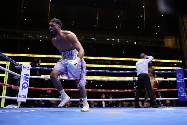 Adam Azim celebrates in the ring