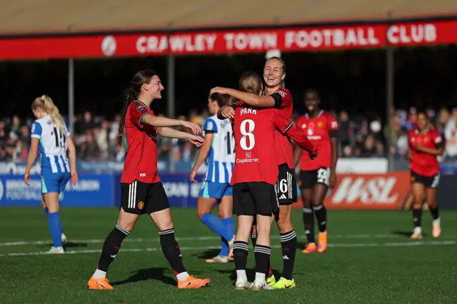 Utd players celebrate scoring a goal at brighton