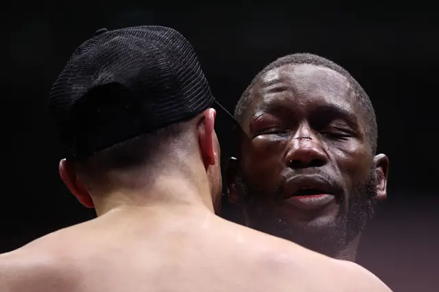 Ekow Essuman  eye is swollen and closed as he hugs Jack Catterall