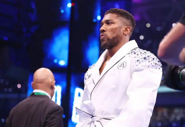 Anthony Joshua in a white robe in the ring