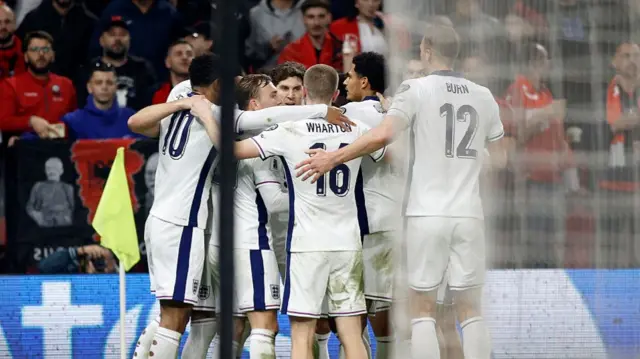 England players celebrate together after Harry Kane's goal