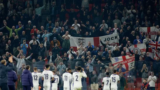 England players applaud the travelling England fans after full-time in Albania.