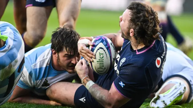 Ewan Ashman celebrates after scoring a try for Scotland against Argentina