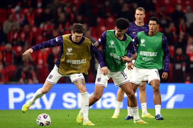 John Stones and Nico O'Reilly of England warm up
