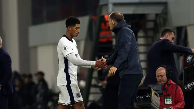 Thomas Tuchel shakes Jude Bellingham's hand after coming off as a substitute.