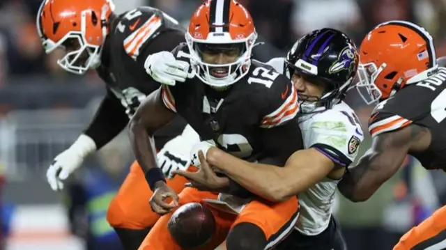 Cleveland Browns quarterback Shedeur Sanders fumbles as he is sacked by Baltimore Ravens safety Kyle Hamilton