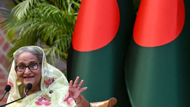 Bangladesh's Prime Minister Sheikh Hasina gestures while speaking to the media, a day after she won the 12th parliamentary elections, in Dhaka on January 8, 2024