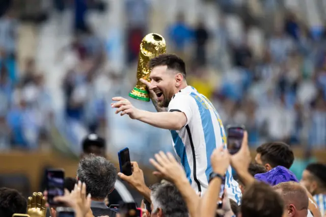 Lionel Messi of Argentina celebrates with the World Cup Trophy