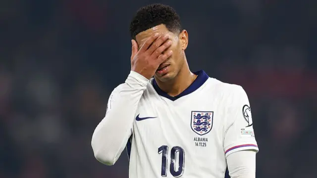 Jude Bellingham puts his hand to his face in frustration.