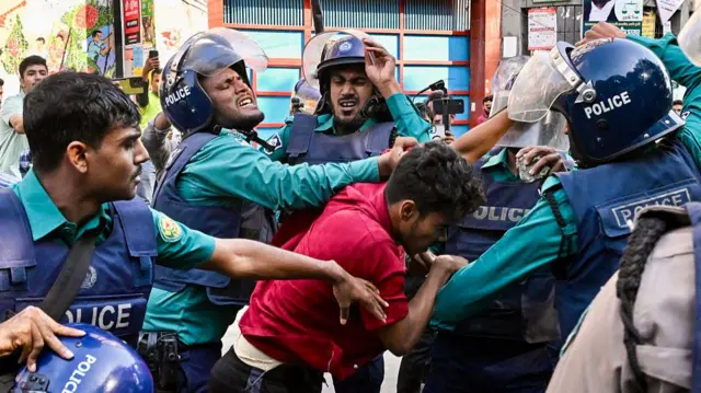 Police personnel scuffle with a demonstrator during an attempt to demolish the residence of Sheikh Mujibur Rahman, Bangladesh's first president and father of the country's fugitive prime minister Sheikh Hasina in Dhaka on November 17, 2025