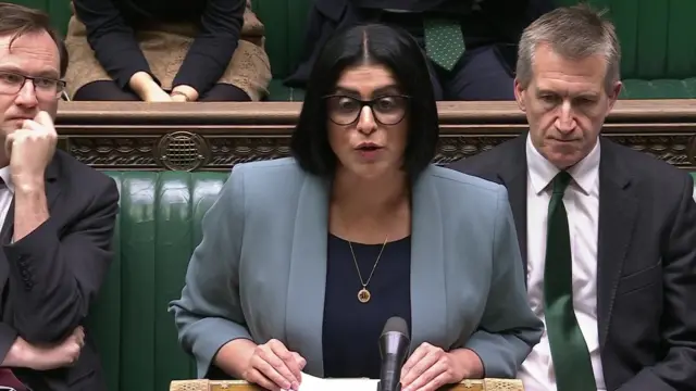 Shabana Mahmood stands in the House of Commons and speaks into a microphone