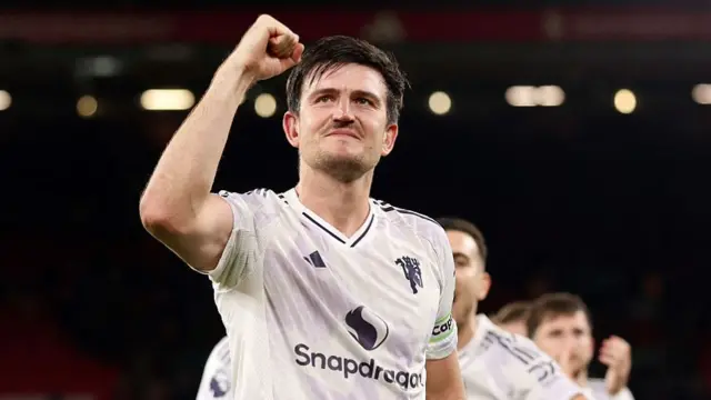 Harry Maguire celebrates with Man Utd fans at Anfield