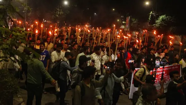 Members of Jatiya Chhatra Shakti march with torches in the Dhaka University area demanding the highest punishment for Sheikh Hasina in Dhaka, Bangladesh, on November 16, 2025