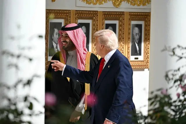 Trump and bin Salman in the president's gallery of former presidents. Trump is pointing at one of the portraits.