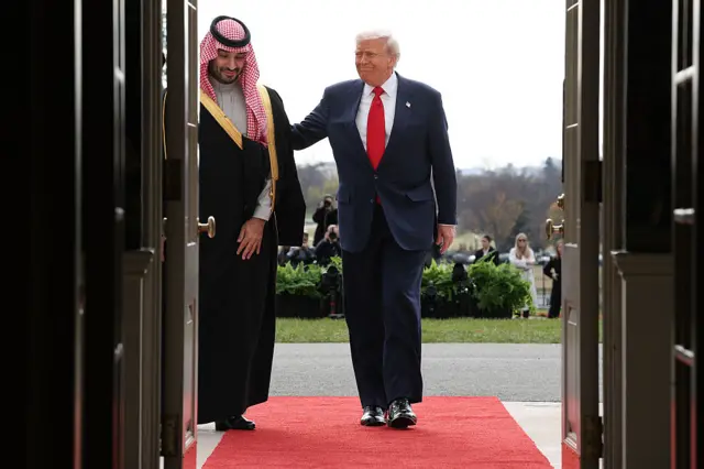MBS and Trump walking into the White House on a red carpet