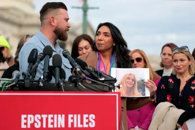 WASHINGTON, DC - NOVEMBER 18: Sky Roberts (L), brother of Virginia Giuffre, who was abused by Jeffrey Epstein, and his wife Amanda Roberts hold up a photo of Giuffre as they speak during a news conference with lawmakers on the Epstein Files Transparency Act outside the U.S. Capitol on November 18, 2025 in Washington, DC. Virginia Giuffre died by suicide in April 2025. The House is expected to vote today on the legislation, which instructs the U.S. Department of Justice to release all files related to the late accused sex trafficker Jeffrey Epstein