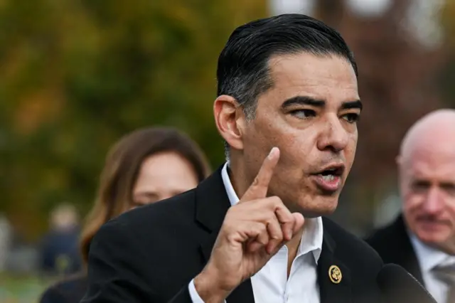 Rep Robert Garcia gestures with his finger while speaking to reporters outside the US Capitol