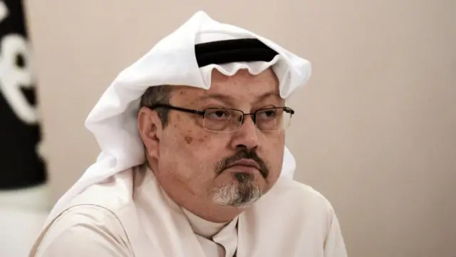 Jamal Khashoggi looks on during a press conference in the Bahraini capital Manama in December 2014