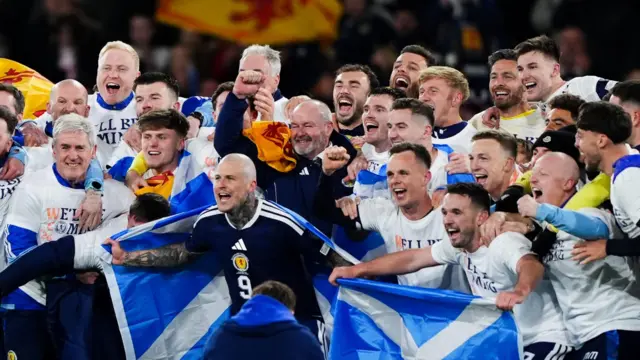 cotland players and manager Steve Clarke celebrate after they qualified for the 2026 World Cup after beating Denmark 4-2 in their final qualifier at Hampden Park,