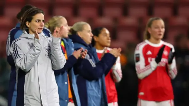 Slegers and the Arsenal players applaud the fans at the end of the NLD