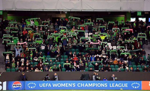 Wolfsburg fans hold up scarves